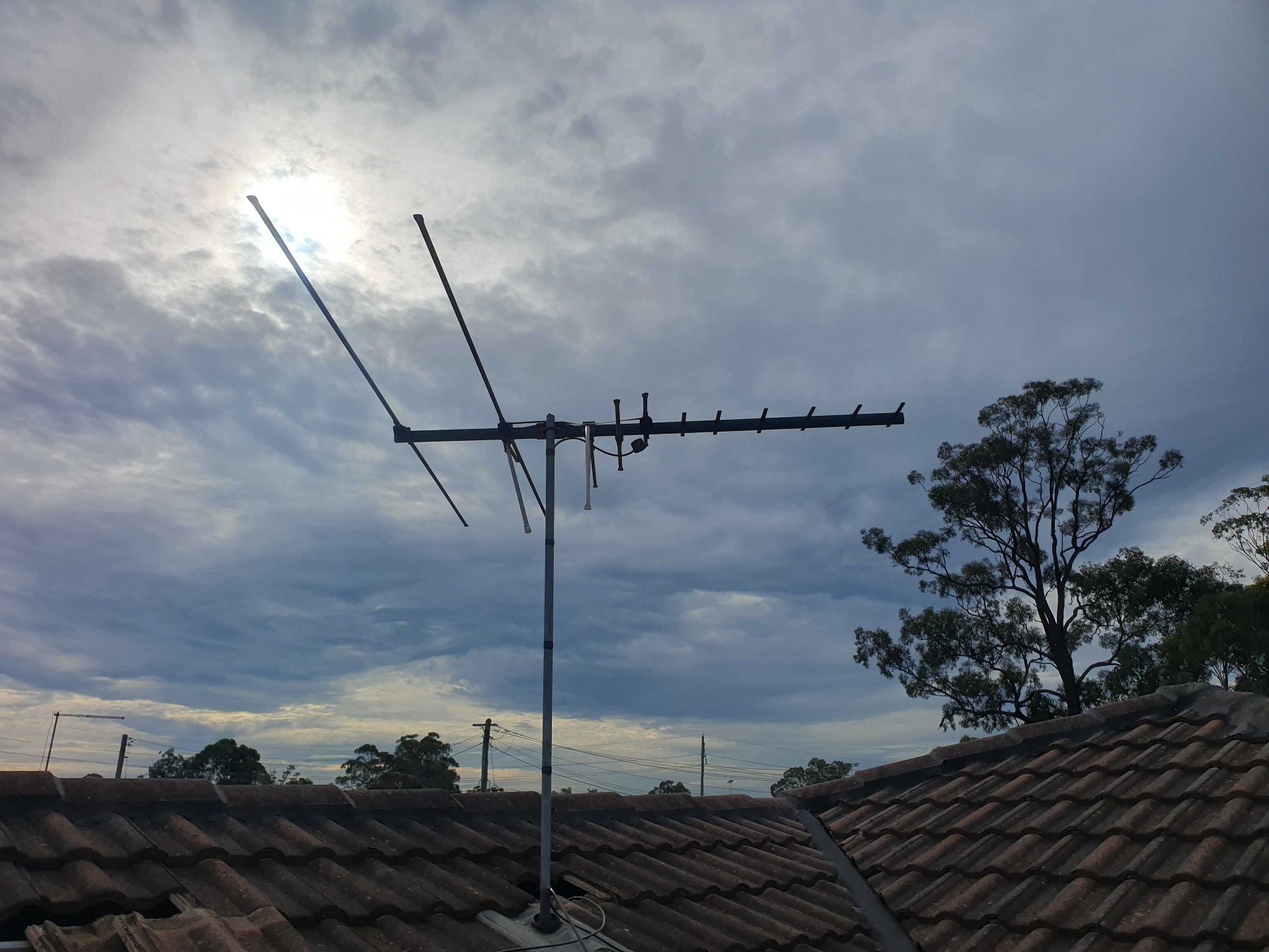 Before photo of an old weathered antenna on a roof in Castle Hill with a failing mount that was leaking water into the roof cavity