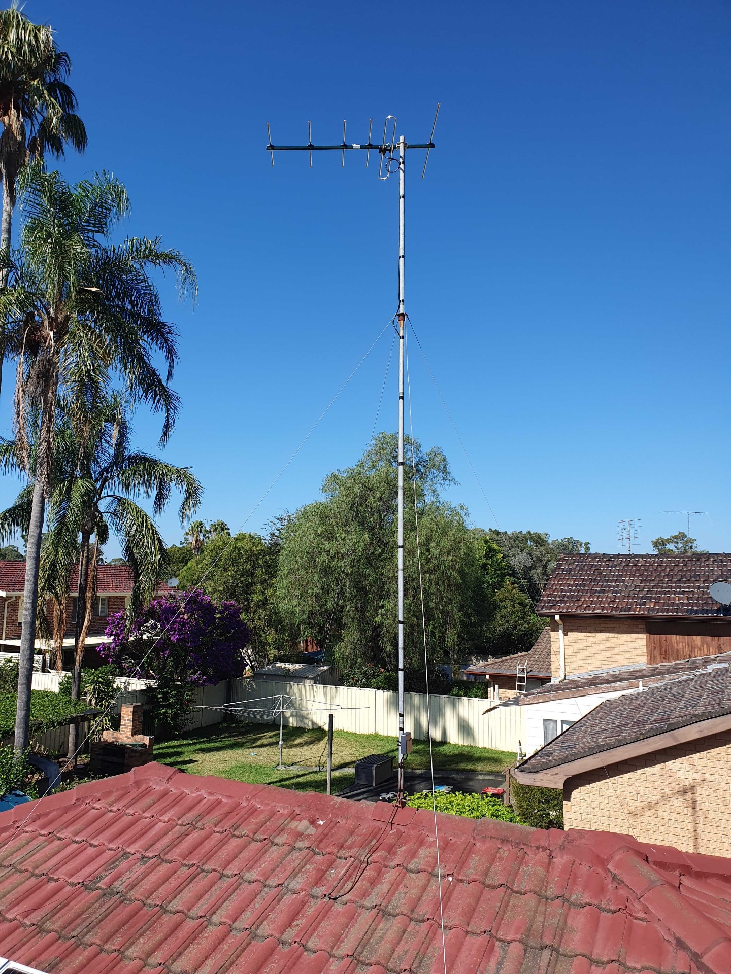 New digital TV antenna installed on a secured 15-foot mast with guide wires on a rooftop in Emu Heights